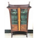 ARTS AND CRAFTS MAHOGANY DISPLAY CABINET with a shaped raised back and pierced shaped sides above