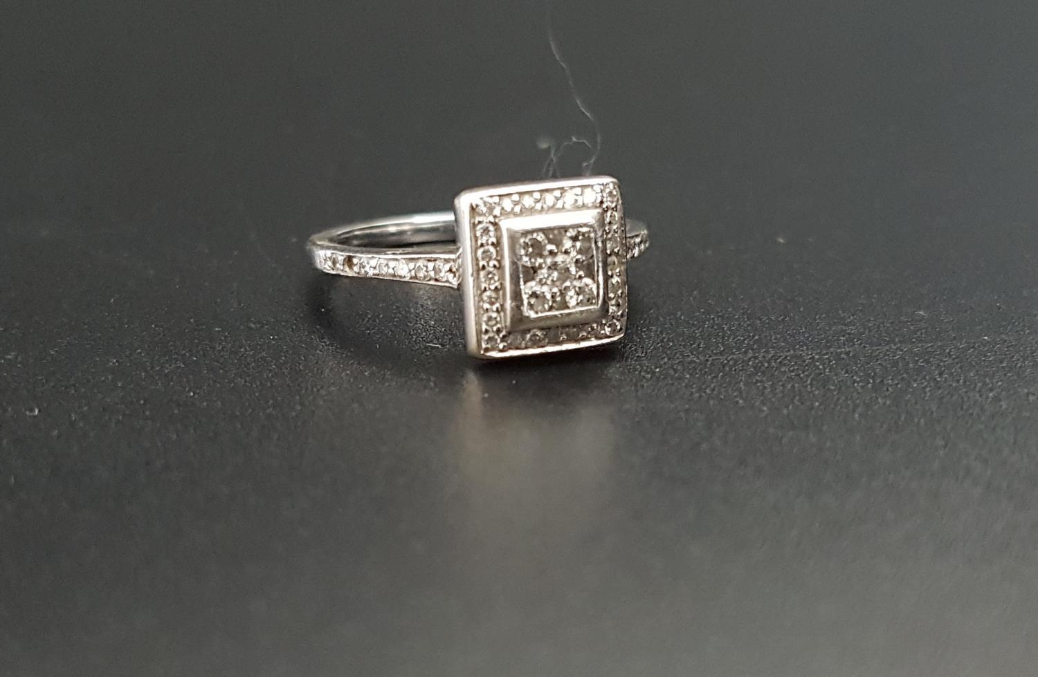 DIAMOND CLUSTER RING in eighteen carat white gold with square setting, the diamonds totalling