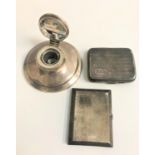 SELECTION OF SILVER ITEMS comprising a capstan inkwell, with rubbed hallmarks; and two cigarette