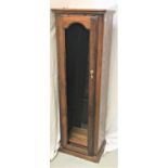 OAK DISPLAY CABINET of narrow proportions, with a moulded top above an arched glass door opening