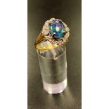 ATTRACTIVE OPAL TRIPLET AND DIAMOND CLUSTER RING the central oval opal triplet in twelve diamond