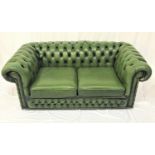 CHESTERFIELD TWO SEAT SOFA in green leather with a button back and arms, and decorative metal stud