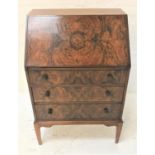 WALNUT AND FIGURED WALNUT BUREAU with a fall front revealing a fitted interior above three long