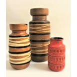 THREE WEST GERMAN POTTERY VASES of graduated size, the two largest with spiraling decoration, the
