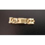 FOURTEEN CARAT GOLD RING the central panel flanked by watch strap style band, ring size T and