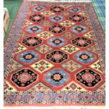 BOKHARA STYLE RUG with a terracotta ground with blue, cream and pale green lozenge decoration,