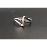 ATTRACTIVE DIAMOND SET RING the ten diamonds in wavy shaped setting, in nine carat white gold,