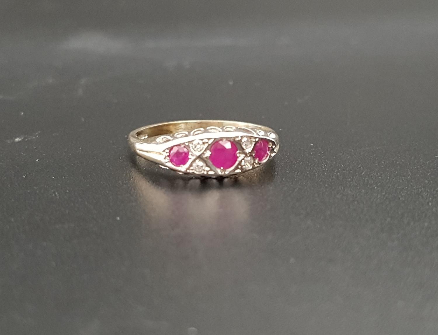 RUBY AND DIAMOND RING the three graduated rubies with small diamonds between, on nine carat gold