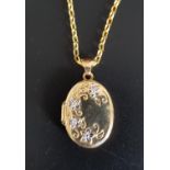 NINE CARAT GOLD LOCKET PENDANT with floral decoration, on nine carat gold chain, total weight