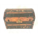 DOME TOP CABIN TRUNK with oak banding and reinforced corners, the lid marked T.R.S. and opening to