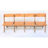 VINTAGE BEECH FOLDING BENCH with four seats below shaped backs, standing on plain supports, 185cm