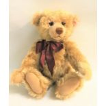 STEIFF GROWLER TEDDY BEAR in golden brown with swivel head and jointed limbs, with burgundy bow