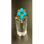 CITRINE AND TURQUOISE CLUSTER RING the four cabochon turquoise stones interspersed with five round