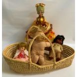 REED MOSES BASKET together with four plastic dolls of various sizes