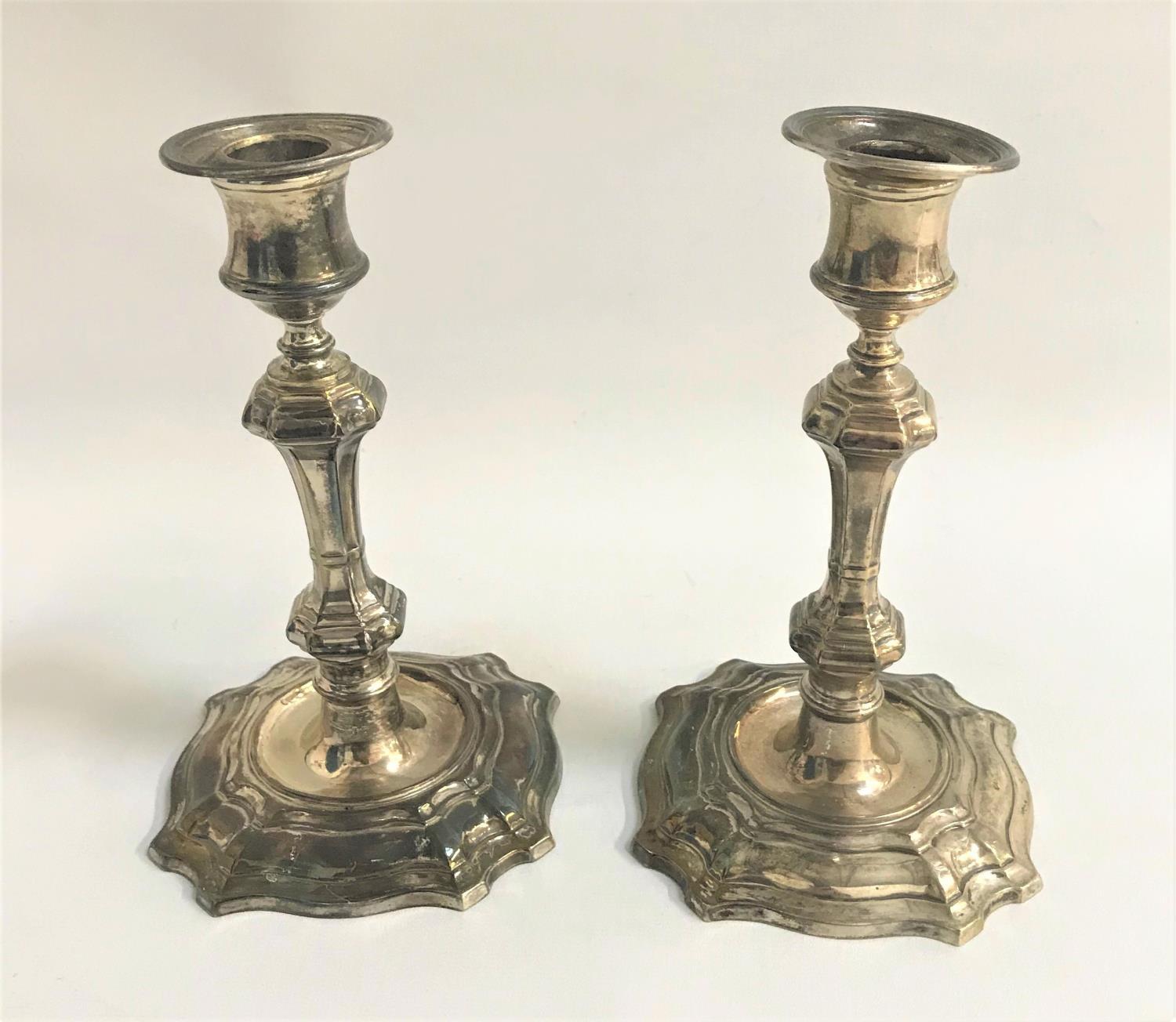 PAIR OF EDWARD VII SILVER CANDLESTICKS the knopped octagonal stems on shaped bases, the bases with