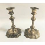 PAIR OF EDWARD VII SILVER CANDLESTICKS the knopped octagonal stems on shaped bases, the bases with