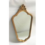 GILT FRAME WALL MIRROR with an arched shaped plate, the frame surmounted with a pierced shell,