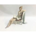 LLADRO PORCELAIN FIGURINE of a seated and reclining ballerina, 24cm high