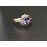 TANZANITE AND DIAMOND CLUSTER RING the central oval cut tanzanite approximately 1.2cts in multi