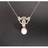 PINK PEARL AND DIAMOND PENDANT the pearl drop below ornate multi diamond setting with bow and swag
