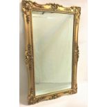 GILT FRAME OBLONG WALL MIRROR the frame decorated with shells and garlands around the plate, with