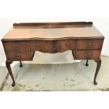 BIETHCRAFT MAHOGANY BOW FRONT KNEEHOLE DRESSING TABLE with a shaped raised back above a shaped