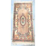 CHINESE WASH RUG with a mushroom coloured ground and central flower motif, encased by a floral
