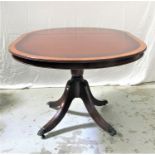MAHOGANY AND CROSSBANDED CIRCULAR DINING TABLE with a pull apart top and extra leaf, standing on a