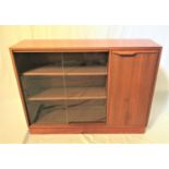 TEAK SIDE CABINET with a plain top above a pair of glass sliding doors with an adjustable shelf, and