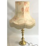 LARGE BRASS TABLE LAMP raised on a circular brass stepped base and shaped column with a floral