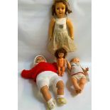 SELECTION OF FOUR PLASTIC DOLLS A Pedigree made in England doll with open and sleeping eyes, dressed