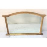 SHAPED GILT FRAME OVERMANTLE MIRROR with an arched frame and bevelled plate, 124cm wide