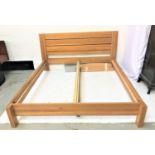 KINGSIZE LIGHT OAK BED with a slatted panel headboard and low panel footboard and slatted base,