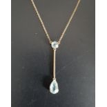 AQUAMARINE DROP PENDANT the pear cut aquamarine suspended from knife edge bar below further round