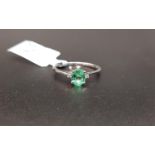 CERTIFIED EMERALD AND DIAMOND THREE STONE RING the central oval cut Zambian emerald weighing 0.48cts