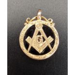 MASONIC FIFTEEN CARAT GOLD AND BLACK AGATE FOB the circular black agate with applied fifteen carat