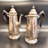 GEORGE V SILVER TEA POT AND COMPANION HOT WATER JUG both of baluster form with scroll shaped