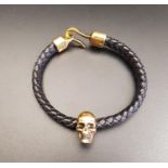 ALEXANDER McQUEEN SKULL LEATHER BRACELET the brass skull on a plaited leather bracelet, with hook