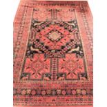 LARGE MOSSOUL WOOL RUG with a terracotta ground decorated with panels of animals and geometric