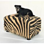 LARGE FOOTSTOOL covered in a printed zebra skin fabric with decorative stud detail, standing on