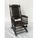 EDWARDIAN MAHOGANY ROCKING CHAIR with a two section padded back above part padded arms and a