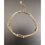 PRETTY EIGHTEEN CARAT ROSE GOLD TWO STRAND BRACELET with white, yellow and rose gold ball detail,