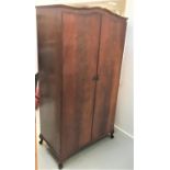 BEITHCRAFT MAHOGANY WARDROBE with a shaped arched top above a pair of shaped doors opening to reveal