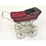 MARMET PRAM with a burgundy body with rain cover and folding hood on a four wheel chrome folding