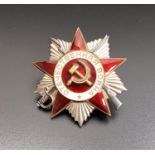 WW II SOVIET RUSSIAN CAP BADGE in white metal and red enamel, centered with the hammer and sickle,