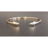 FOURTEEN CARAT GOLD BANGLE with dolphin finials, one in white gold and the other yellow,