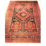 LARGE MOSSOUL WOOL RUG with a terracotta ground decorated with panels of animals and geometric