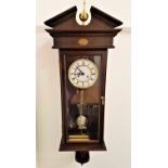 MAHOGANY CASED VIENNA TYPE WALL CLOCK the circular dial with Roman numerals and twin train and