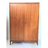 A.YOUNGER LTD TEAK WARDROBE with a plain top above two doors opening to reveal two hanging rails and