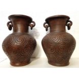 PAIR OF POTTERY BALUSTER VASES with a pair of articulated ring handles to the neck above a body with